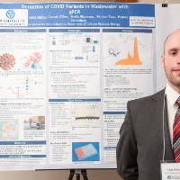Cell and Molecular Biology graduate student, Louis Walter, standing in front of his poster.